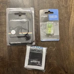 Polaroid Accessory Pack, Lens Cap Strap, Bubble Level (2X), & Memory Card Wallet. Fixed Price $17.50.