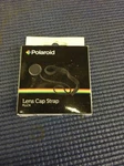 PA1- Polaroid Lens Cap Strap New In Box. Fixed Price $9.85.