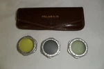 Polaroid Filter Lens W/ Leather Case Yellow #1, Polarizing #2, Half-step #3. Fixed Price $8.00.