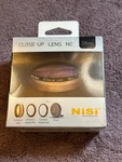 Nisi 58MM Close Up Lens 49 & 52MM Step Rings Case - Never Opened, Sealed!. Fixed Price $50.00.